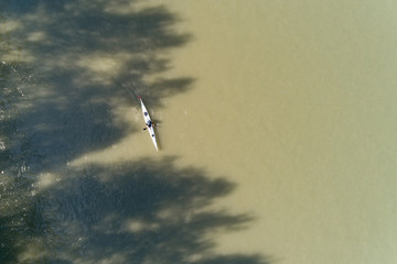  Top view of canoe rowing down, Aerial view of athlete floating on kayaks in the river