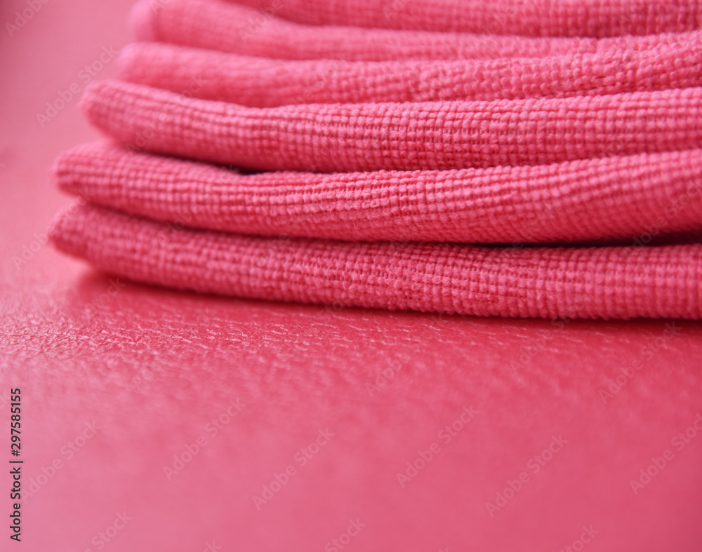 Poster pink towels in a fold on a pink background