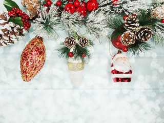christmas fir tree branches with decorations on wooden background