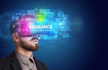 Businessman looking through Virtual Reality glasses with INSURANCE inscription, innovative security concept