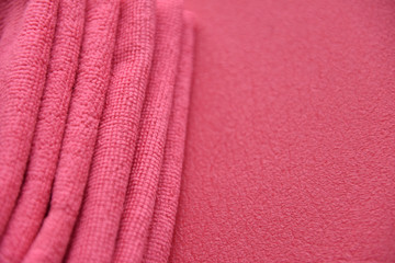 pink towels in a fold on a pink background