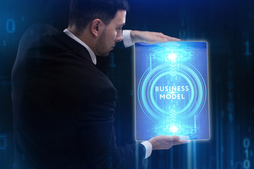 The concept of business, technology, the Internet and the network. A young entrepreneur working on a virtual screen of the future and sees the inscription: Business model