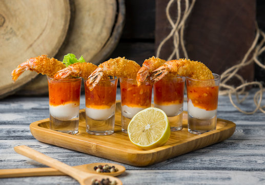 fried shrimp cocktail shots filled with mayonnaise and sweet chili sauce, close up