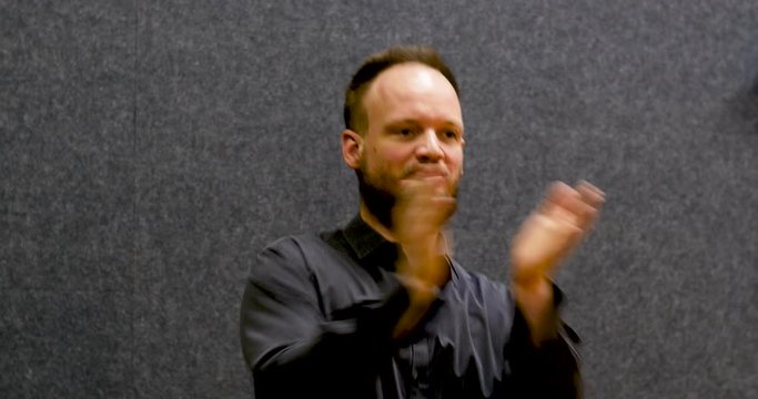 Man playing body percussion on grey background