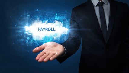 Hand of Businessman holding PAYROLL inscription, successful business concept