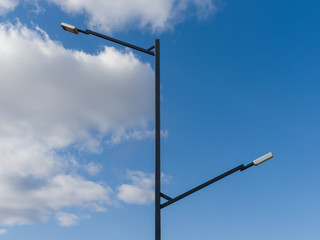 Obraz premium Street lamp modern design. Street lamp of modern design. Elegant metal construction against a blue sky