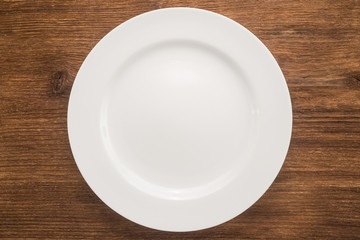 Empty plate on wooden background 	