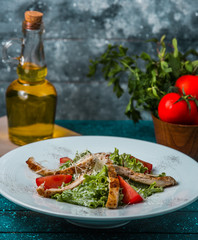 grilled lamb sticks with lettuce, tomato slices, cheese in sauce