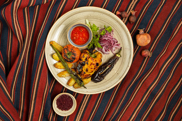 grilled vegetables plate served with tomato, fresh onion slices, dill and coriander
