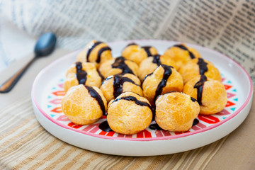 Profiterole with vanilla and chocolate sauce