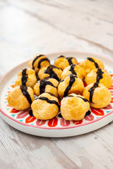 Profiterole with vanilla and chocolate sauce