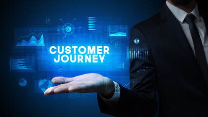 Obraz premium Hand of Businessman holding CUSTOMER JOURNEY inscription, business success concept