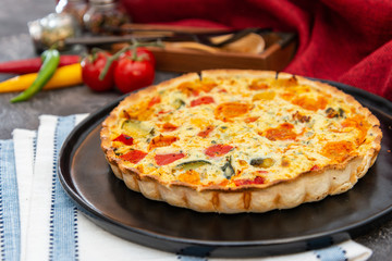 vegetable pie with cherry tomatoes, grilled peppers and courgettes with fresh eggs and fresh cream