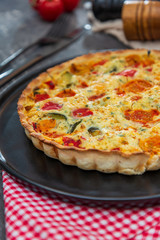 vegetable pie with cherry tomatoes, grilled peppers and courgettes with fresh eggs and fresh cream