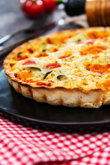 vegetable pie with cherry tomatoes, grilled peppers and courgettes with fresh eggs and fresh cream