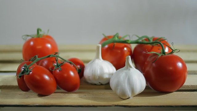 Tomatoes and garlic on a wooden box of vegetables_2