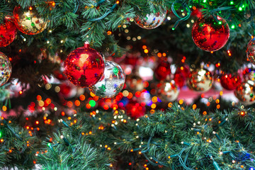 Fototapeta na wymiar Christmas ornaments on the Christmas tree with bokeh background ball