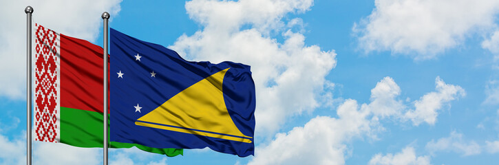 Belarus and Tokelau flag waving in the wind against white cloudy blue sky together. Diplomacy concept, international relations.