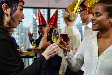 Business men and women with glasses of champagne and wine celebrating Christmas and New Year for success in Business at the Office/Anniversary
