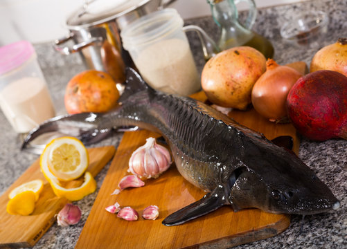 Raw uncooked fish sturgeon at plate before preparing