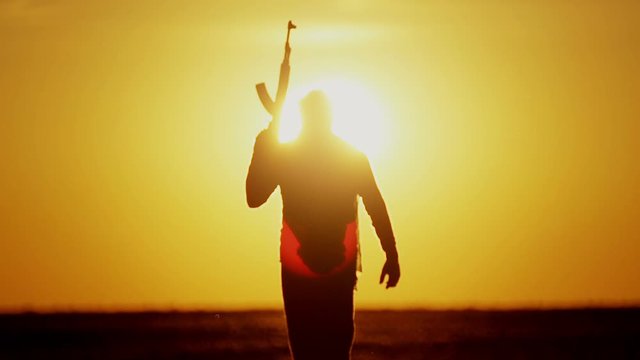 warrior with Kalashnikov at sunset day. fighter is training with a machine gun at sunset.