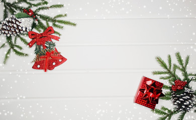 Fototapeta na wymiar christmas decoration and red gift boxes on white wooden background