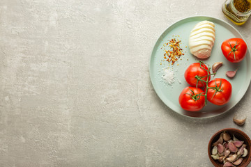Mozzarella and tomatoes, spices and garlic - ingredients for caprese salad