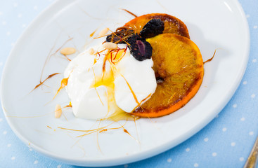 Dessert with caramelized oranges, yogurt, brambleberries