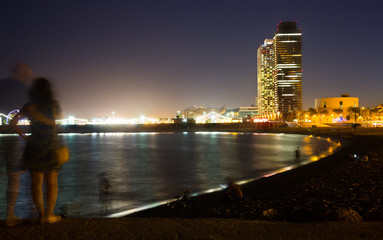 Fototapeta na wymiar Illuminated Barceloneta Beach in summer night