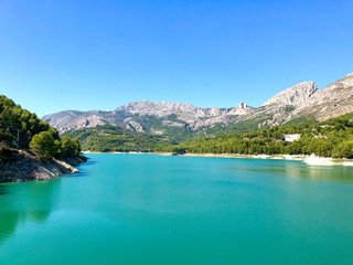 Fototapeta na wymiar The beautiful azure coloured water of the reservoir at Guadalest in Spain