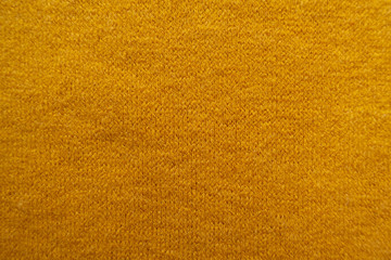 Texture of amber yellow woolen knitted fabric - obrazy, fototapety, plakaty