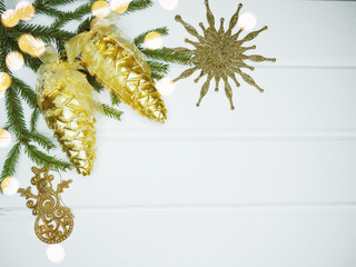 Obraz na płótnie Canvas christmas gold decoration on white wooden background