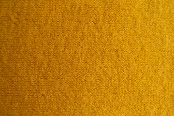 View of amber yellow woolen fabric from above