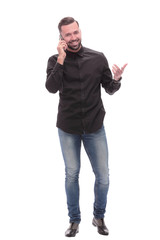 Fototapeta premium in full growth. smiling young man talking on his smartphone
