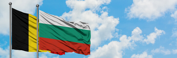 Belgium and Bulgaria flag waving in the wind against white cloudy blue sky together. Diplomacy concept, international relations.