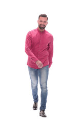 Fototapeta premium smiling young man in jeans stepping forward . isolated on white