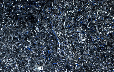 Steel scrap materials recycling. Abstract, background and texture of metal shavings. Aluminum chip waste after machining metal parts on a cnc lathe