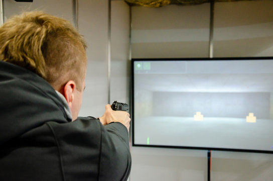 Man shooting in virtual shooting gallery