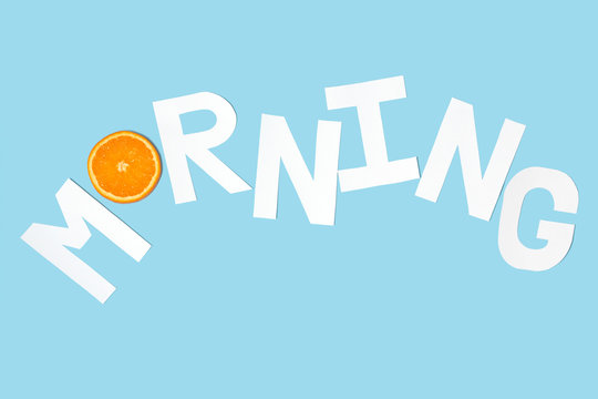 Morning text paper cut decorate with orange on pastel blue background