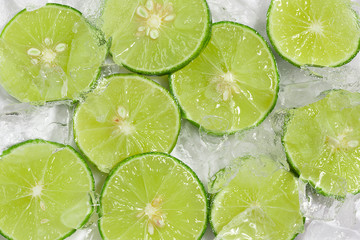 Green lime sliced top view photo shooting on ice