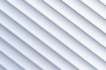 Obraz premium Roller shutter texture. Background with metal stripes in white. Iron roller shutters of white color. Abstract background for wallpaper in the form of straight lines.