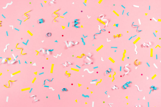 Colorful Paper Confetti Exploding On Pastel Pink Background