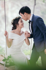 Beautiful wedding couple in the outdoor wedding ceremony in the natural garden.