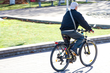 Elderly man on a bicycle. Healthy lifestyle in old age. Retired Freedom. Sports of the elderly. Unbending character.