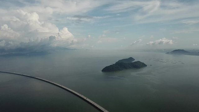 Aerial Penang Second Bridge (Sultan Abdul Halim Muadzam Shah Bridge) and green Pulau Aman in blue sky white cloud.