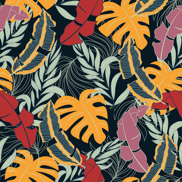 Fashionable seamless tropical pattern with bright red and yellow plants and leaves on dark background.  Vector design. Jungle print. Floral background.  Printing and textiles. 