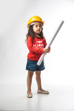 Small Indian girl engineer with yellow hard Hat and Drawing paper roll or plan, isolated over white background