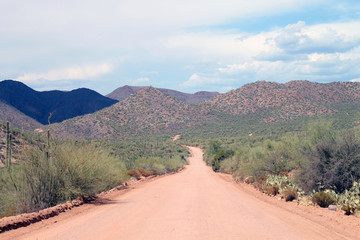 The unpaved red sandy street