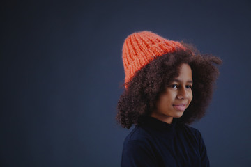 Lovely stylish teenage girl wearing bright knit hat