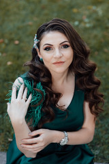 Fashion photo of beautiful girl with beautiful make up, showing emotions. Beautiful woman with long brown curly hair. Portrait of a pretty young adult girl. Sexy face of an attractive lady posing 